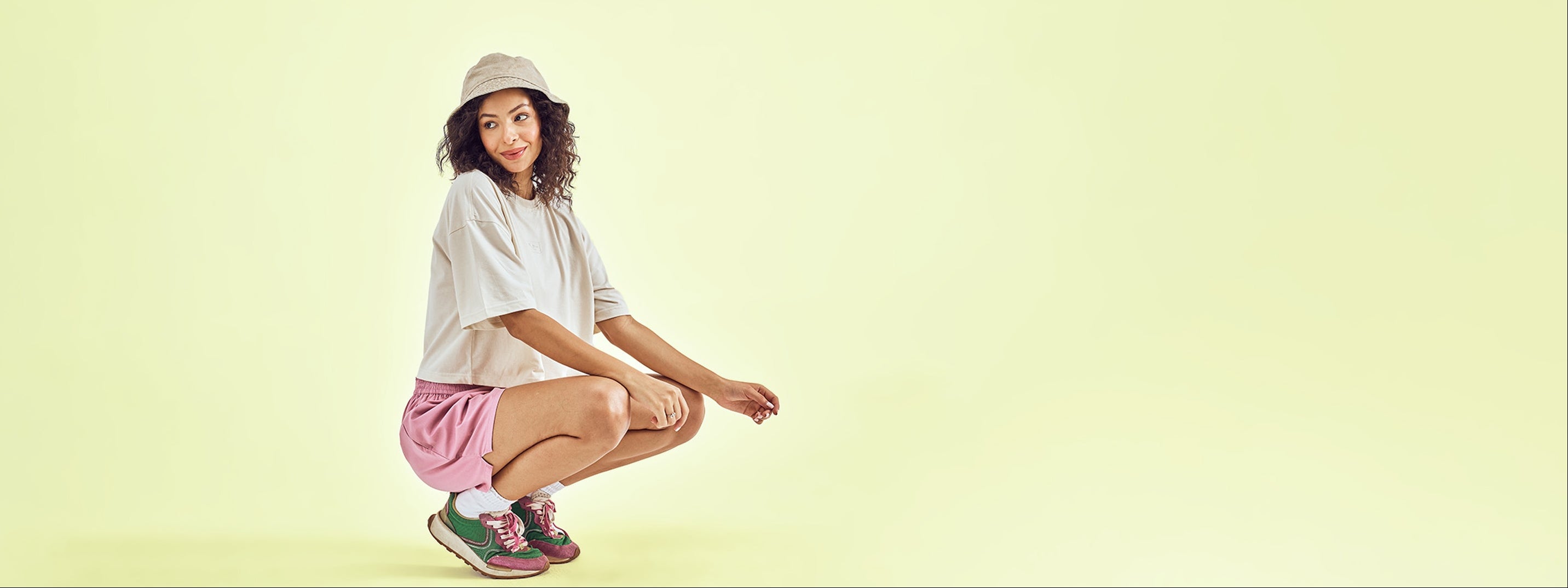 Woman posing on a light green background